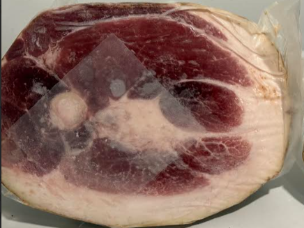Jake+Moore+-+Screenshot+2026-01-15+145433 Sliced cured meat showing marbled fat and lean sections, packaged for freshness. Ideal for gourmet sandwiches and charcuterie boards.